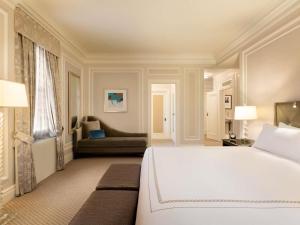 a bedroom with a large white bed and a couch at Fairmont Chateau Laurier in Ottawa