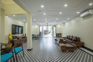 a lobby with couches and chairs and a table at Tom Central Homestay in Sapa