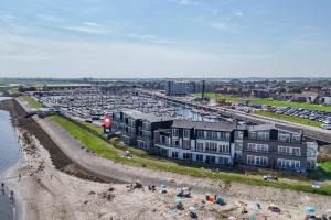 an aerial view of a beach with a parking lot at Vakantiewoning aan het strand - tuin en terras met haven- & zeezicht - Vista Maris - Nr 14 in Sint Annaland +42 photos