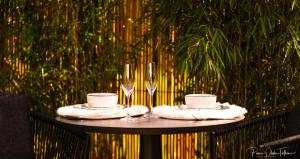 a table with two cups and glasses on it at Le Jardin Secret in Waterloo