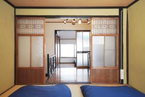 Ένα ή περισσότερα κρεβάτια σε δωμάτιο στο Kyoto Gojo Guest House