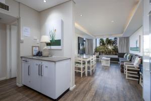 a living room with a kitchen and a living room with a couch at The Breakers 310 in Durban