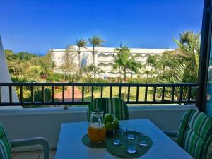 a table with a glass of orange juice on a balcony at The Breakers 310 in Durban