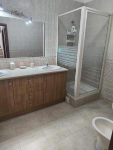 a bathroom with a shower and a sink at Santa Rita Guest House in Olhão +51 photos