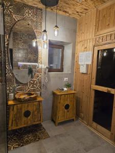 a bathroom with a sink and a mirror at DRUMUL DOMNISORILOR c in Buşteni +81 photos
