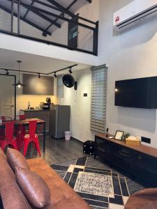 a living room with a couch and a table at Industrial Loft Tinyhouse Homestay - 2 Queen Bed, Free Netflix, Prime & Wi-Fi Near Bukit Mertajam in Kubang Semang