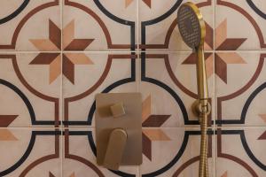 a bathroom with a shower and a blow dryer on a wall at Hetman Main Square Apartments in Krakow