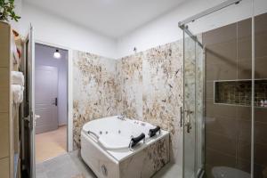 a bathroom with a bath tub and a shower at Vila del Mar in Ksamil +69 photos