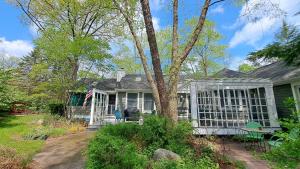 a house with a greenhouse in the yard at Wine Down in Gordon Beach