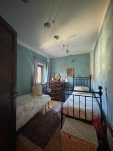 a bedroom with two beds and a dresser at Il Mulino esclusivo soggiorno in Colle