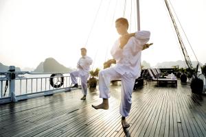 two men in white doing martial arts on a boat at Hera Classic Boutique Cruise in Ha Long +40 photos