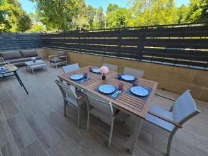 a wooden table and chairs on a patio at Piso de lujo con gran terraza in Sanxenxo