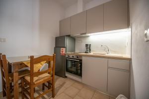 a small kitchen with a table and a sink at Lilian Beach Front 3 Skopelos in Panormos Skopelos