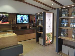a wine shop with a tv and shelves of wine bottles at Apartment Peer in Leitring