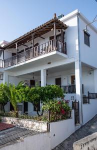 una casa bianca con balconi e fiori di Lilian Beach Front 3 Skopelos a Panormos Skopelos