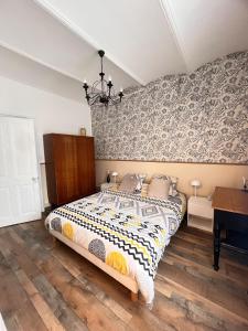 a bedroom with a bed and a wall at Maison Gabriel in Lamastre