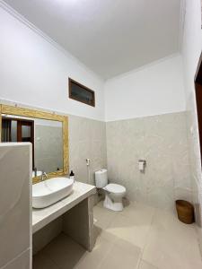 a bathroom with a sink and a toilet at parida bungalow in Gili Islands +39 photos