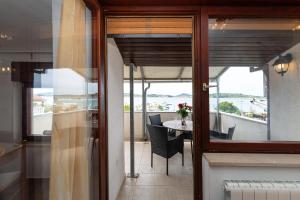 a room with a balcony with a table and chairs at Spacious Apartments by the Sea in Srima, Vodice in Srima