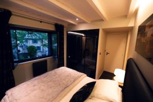a bedroom with a bed and a large window at La Sainthilarienne in Saint-Lary-Soulan
