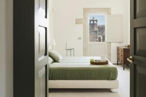 Ένα ή περισσότερα κρεβάτια σε δωμάτιο στο La Canonica Suites