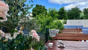 a garden with a wooden table and a bench at Villa Ivanovic in Budva +57 photos