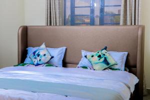 Ένα ή περισσότερα κρεβάτια σε δωμάτιο στο Haven Suites Bnb - Runogone
