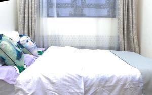 Ένα ή περισσότερα κρεβάτια σε δωμάτιο στο Haven Suites Bnb - Runogone