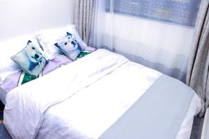 Ένα ή περισσότερα κρεβάτια σε δωμάτιο στο Haven Suites Bnb - Runogone