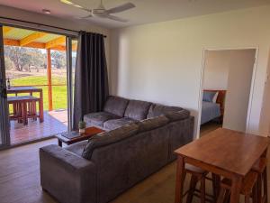 a living room with a couch and a table at Hideaway Studio Rutherglen in Rutherglen