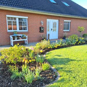 a house with a flower garden in front of it at Ferienhaus Sophie in Diekhusen-Fahrstedt