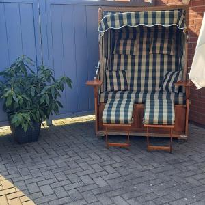 a chair sitting on a patio next to a plant at Ferienhaus Sophie in Diekhusen-Fahrstedt