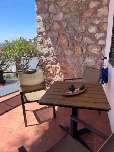 a wooden table with a plate of food on a patio at Apartamento Islas Medas WIFI y PARKING GRATIS in L'Estartit