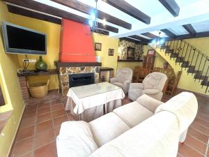 a living room with a couch and a fireplace at Casa Gómez in Gaucín