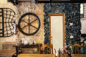 a dining room with a wall with a wheel on it at Casa- event home in Jaffa in Tel Aviv
