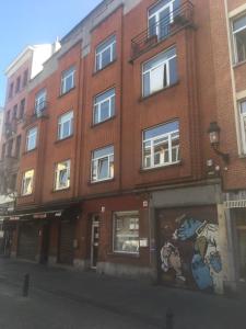 a brick building with a mural on the side of it at Centre de Bruxelles, Studio C in Brussels