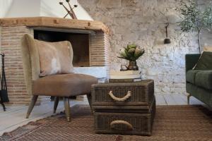 a living room with a chair and a fireplace at Casa Degrassi - Main square - Seaview in Vrsar