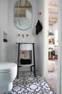 a bathroom with a toilet and a mirror at Casa Degrassi - Main square - Seaview in Vrsar