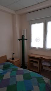 a bedroom with a bed and a lamp in a window at L' Amabile Volpe - Via Carlo Levi 2&2 in Pianoro