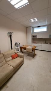 a living room with a couch and a table at L' Amabile Volpe - Via Carlo Levi 2&2 in Pianoro
