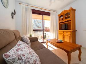 a living room with a couch and a coffee table at Zafiro Calpe by Concept Flats in Ifach