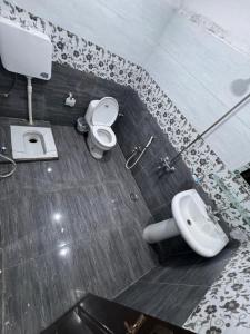 a bathroom with a toilet and a sink at Millat Guest House G94 in Islamabad