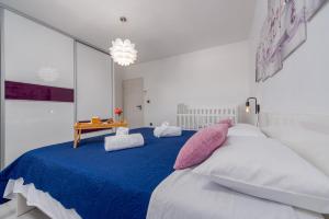 a bedroom with a large bed with pink and white pillows at Villa Family Oasis Nin ZadarVillas in Nin +44 photos