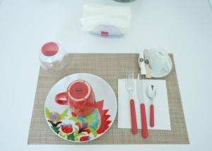 a table with a white plate with a redragon at Magna Domus in Bitetto