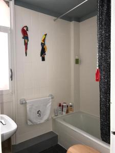 a bathroom with a tub and a toilet and a sink at Cosy apartment with fabulous SEA VIEWS 70's style in Sant Feliu de Guixols