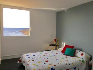 a bedroom with a bed with a window at Cosy apartment with fabulous SEA VIEWS 70's style in Sant Feliu de Guixols