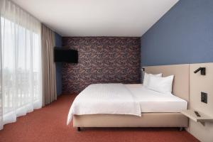 Postel nebo postele na pokoji v ubytování b-smart hotel Arbon