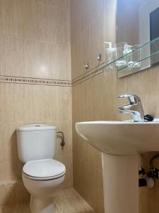a bathroom with a toilet and a sink at Vistas al mar, a 1 min de la playa, terraza, wifi in Laredo +29 photos
