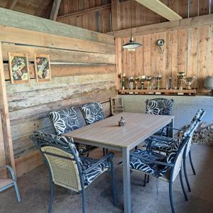 a table and chairs in a room with wooden walls at Ferienhaus Schlossblick in Landl +30 photos