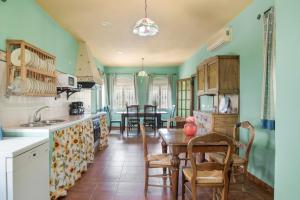 a kitchen with a table and a dining room at Casa Rural Cantarrana in Arriate