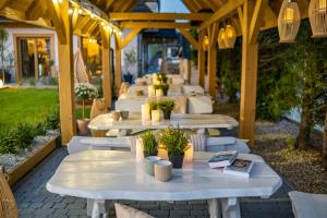 a row of white tables and chairs on a patio at Panocek in Białka Tatrzańska